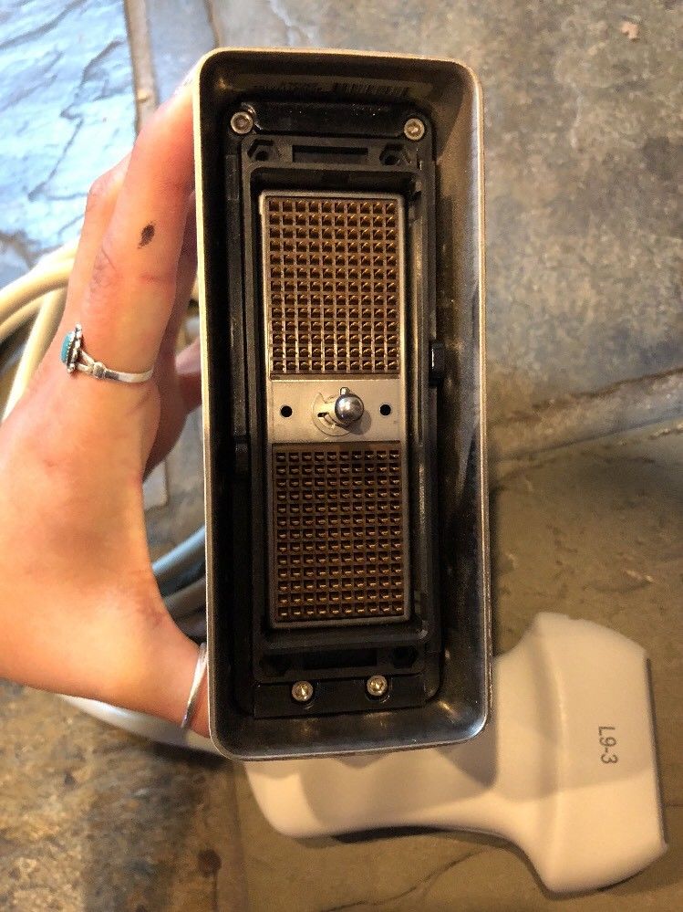 a person holding a small probe head