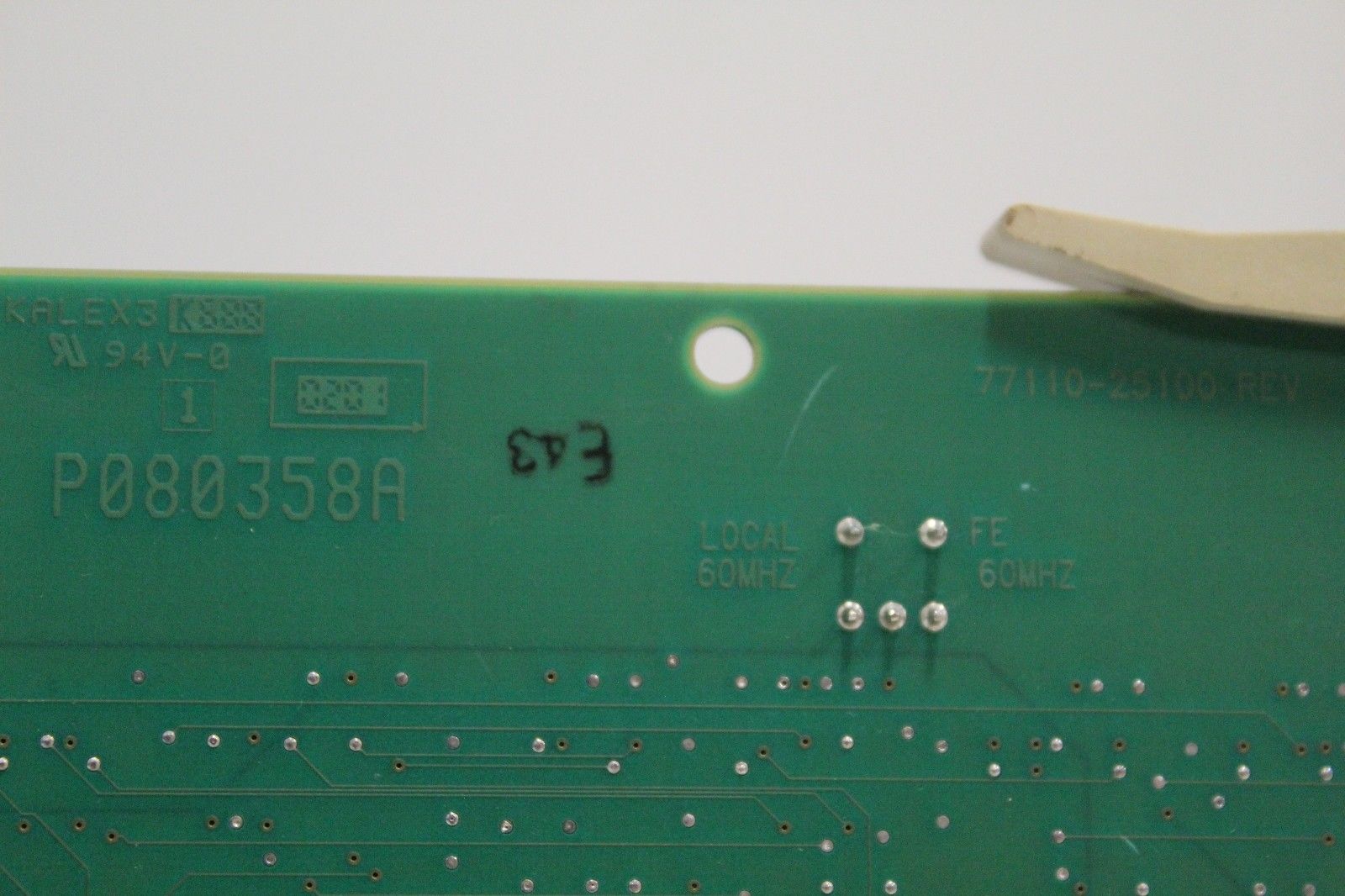 a close up of a circuit board with a pair of scissors