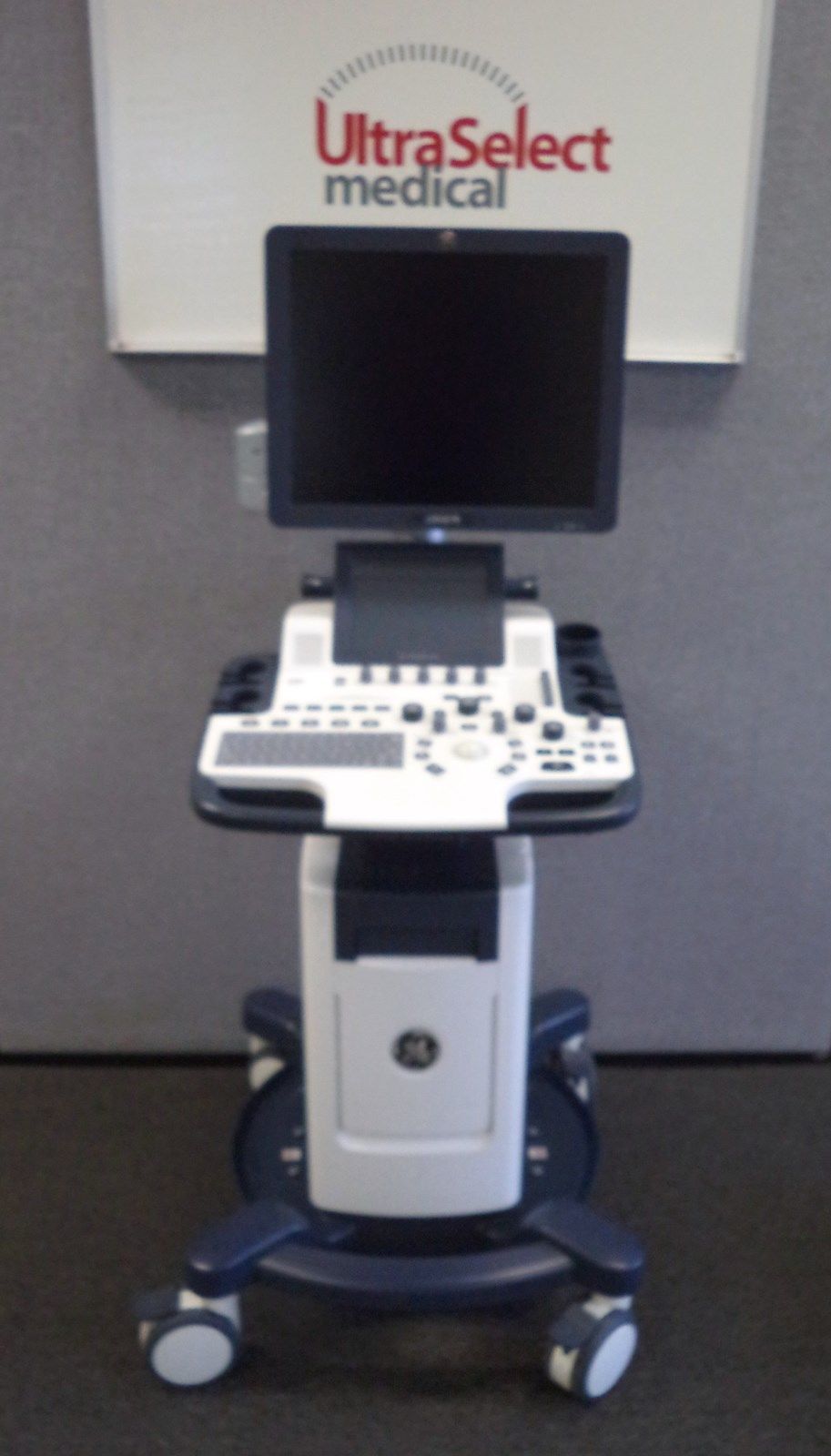 a laptop computer sitting on top of a medical cart