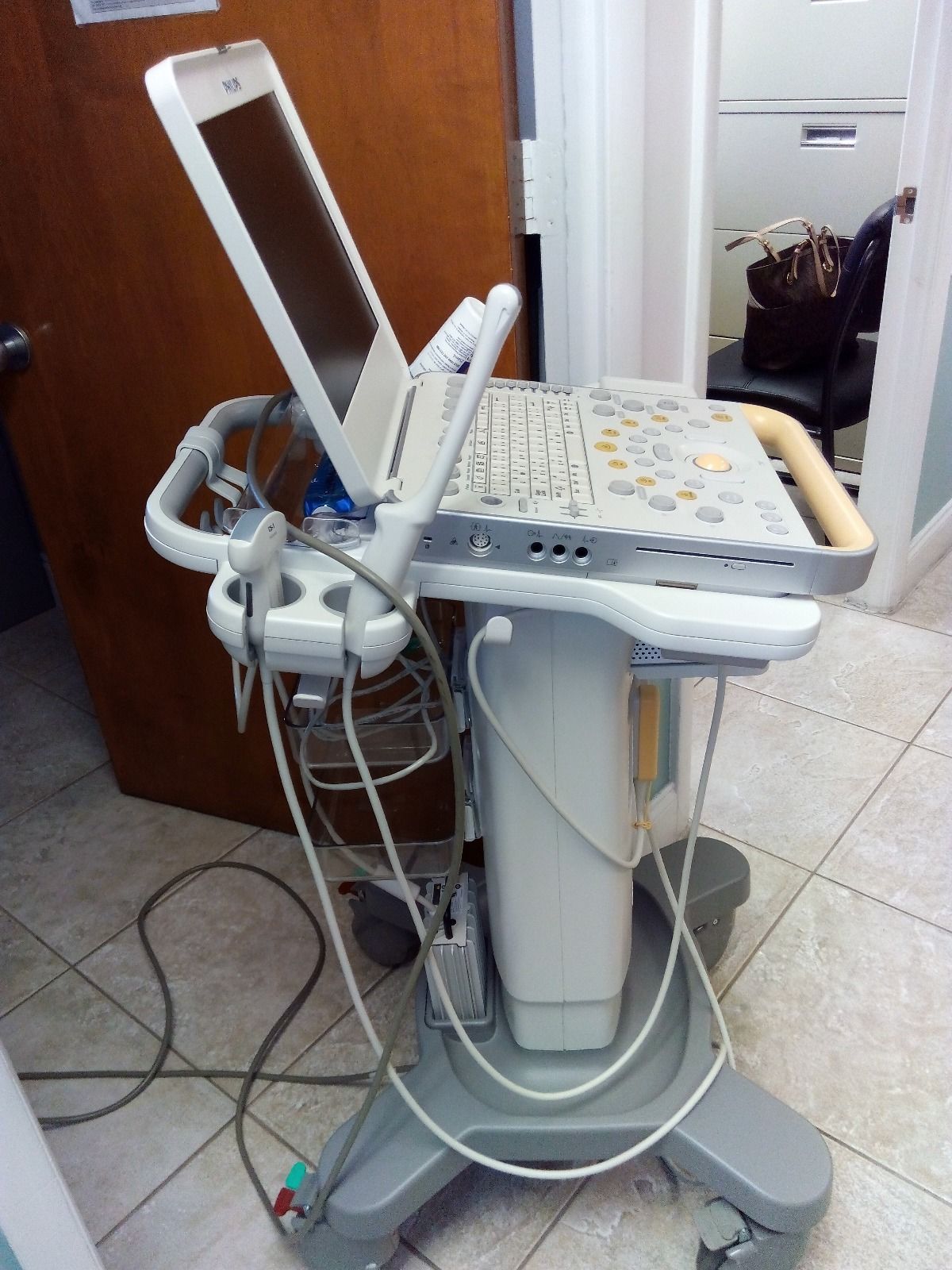 a laptop computer sitting on top of a medical cart