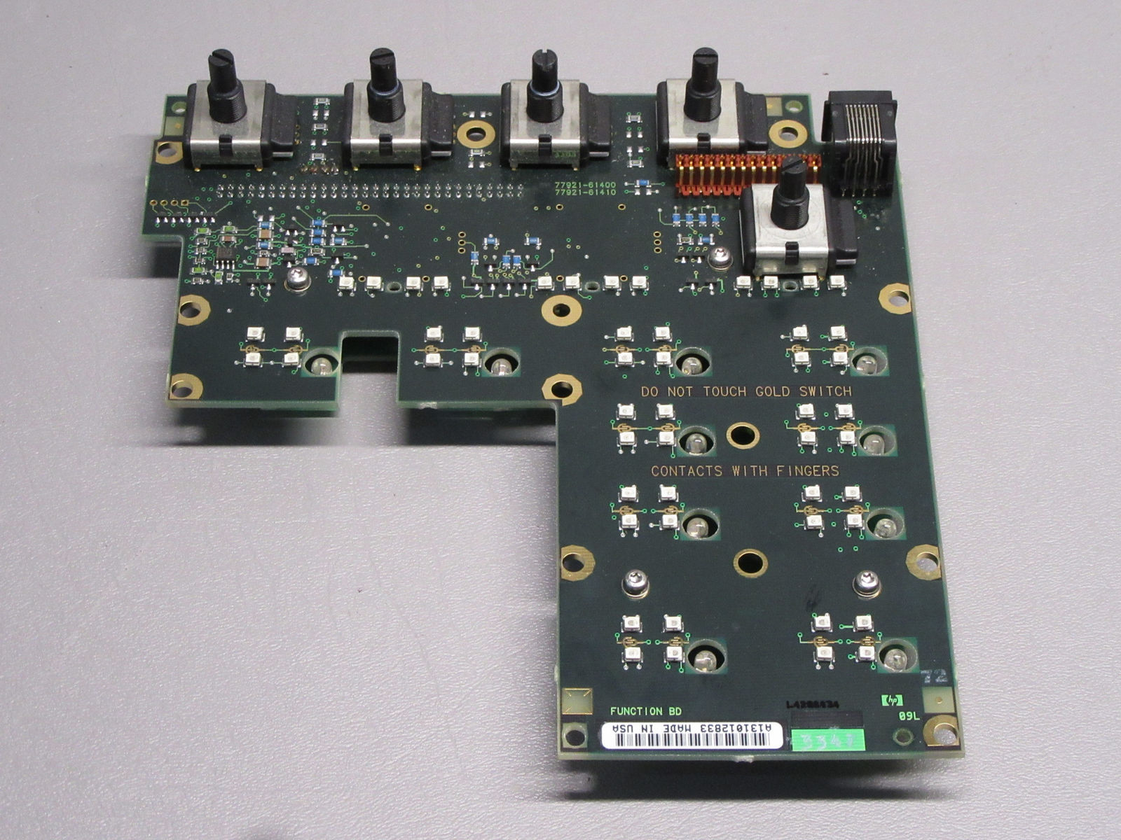 a close up of a circuit board with many screws