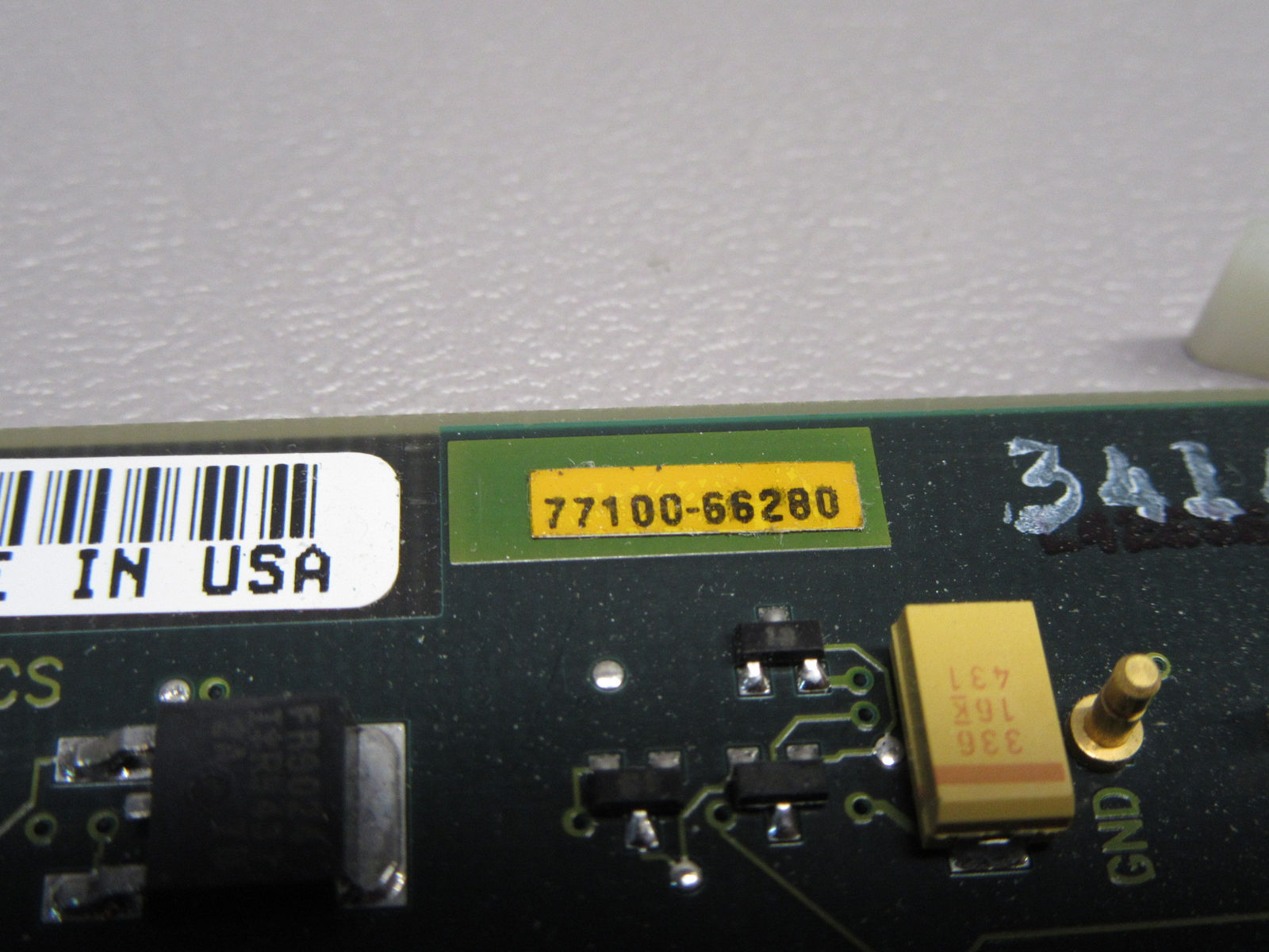 a close up of a circuit board with a bar code on it