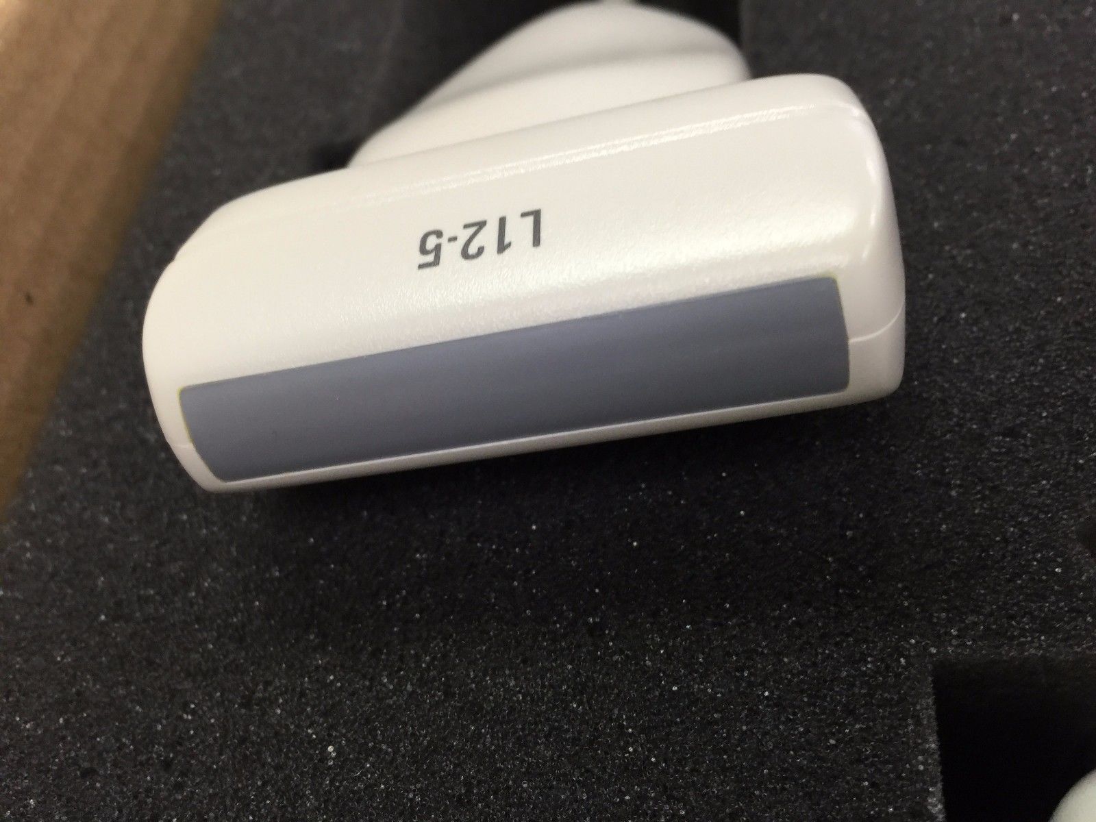 a close up of a white object on a black surface